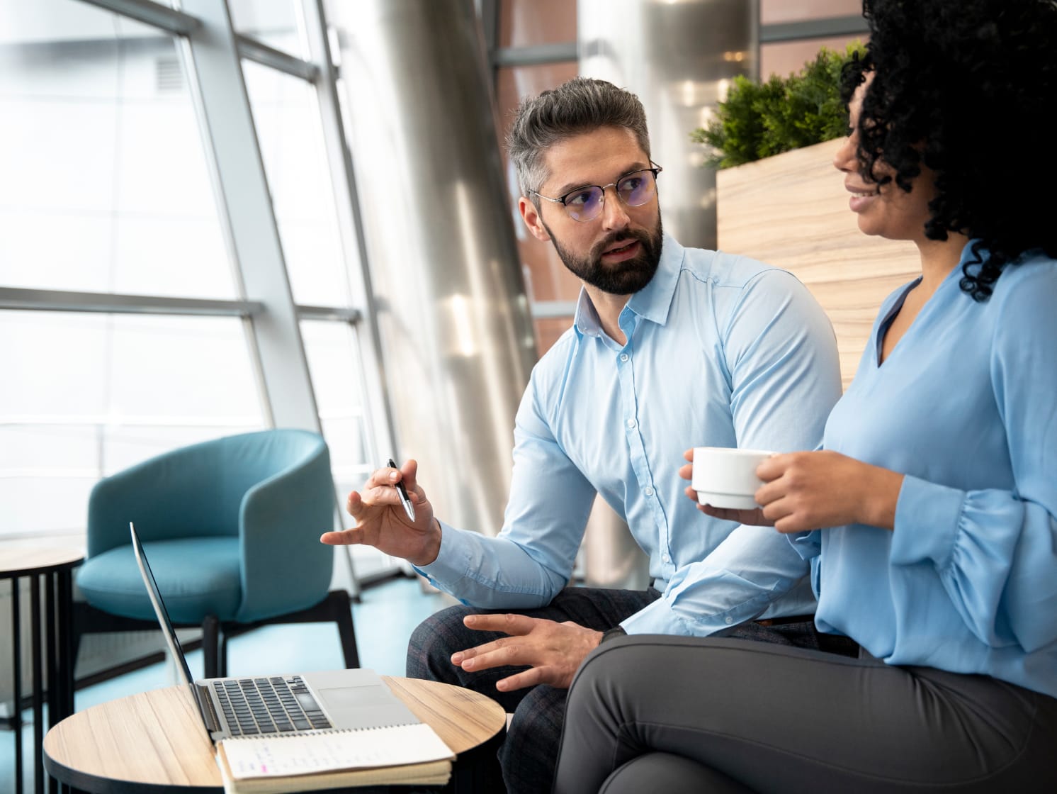 Two colleagues discussing in an office