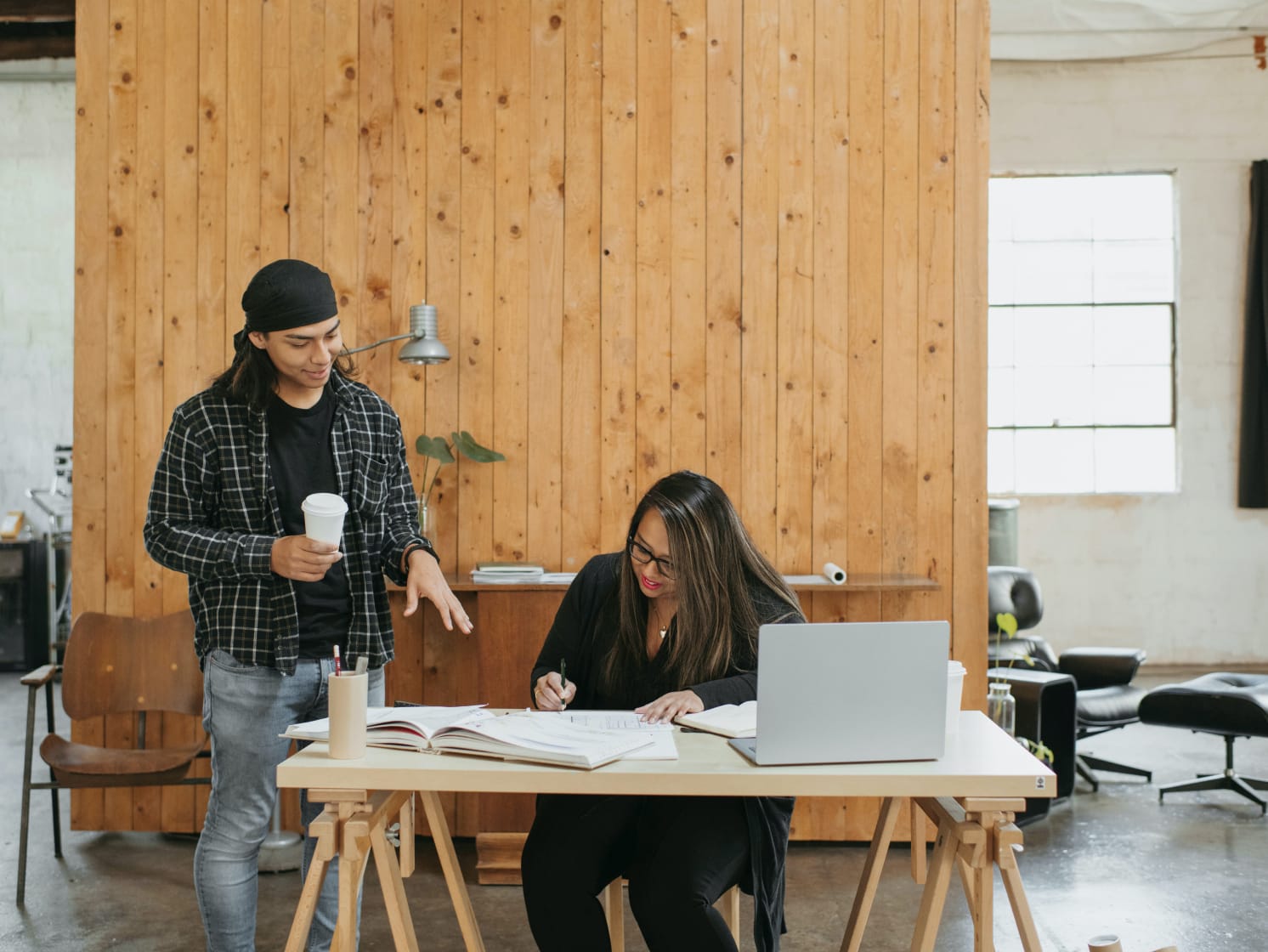 two colleagues evaluating risks of outsourcing